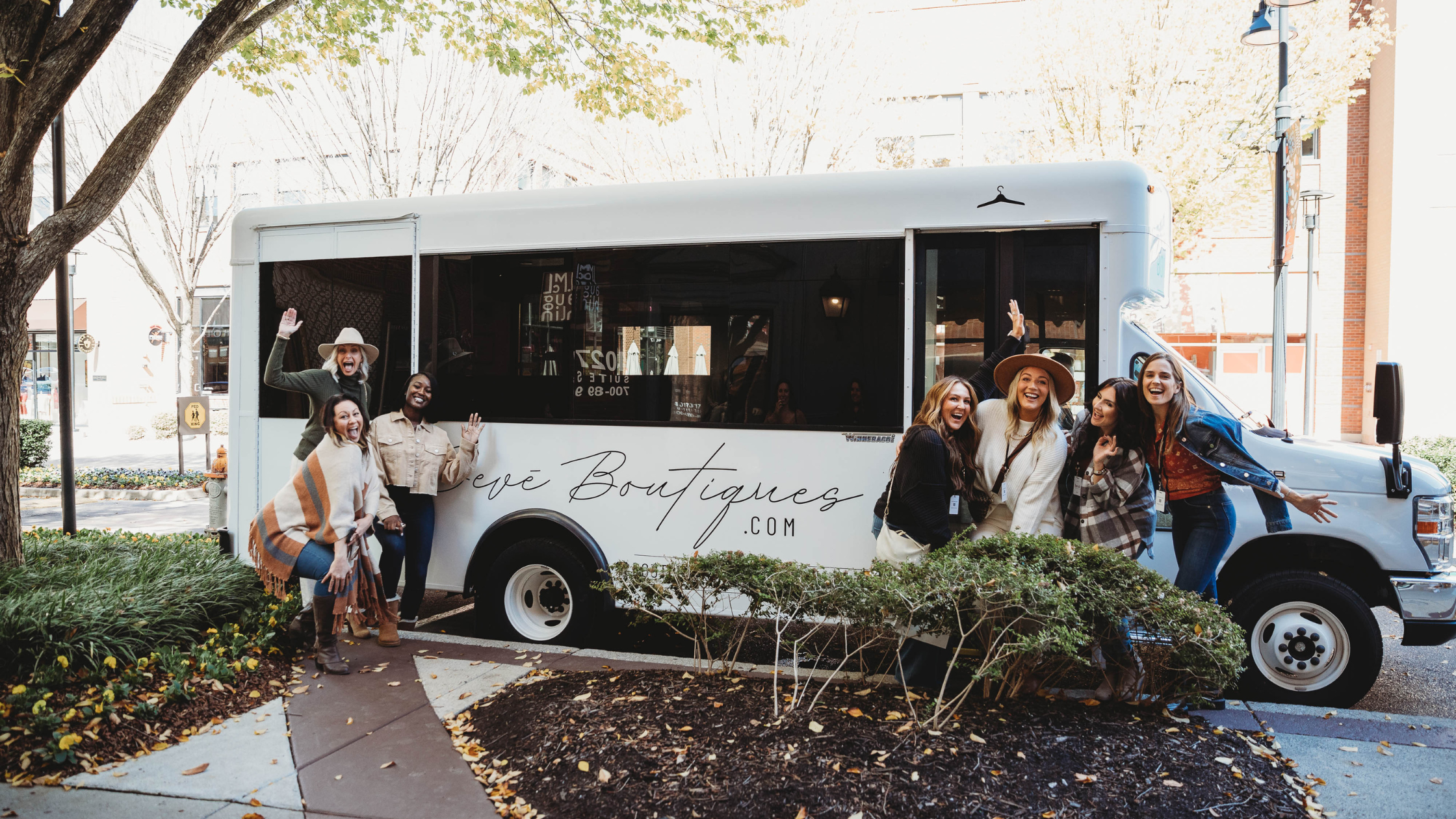 group of women standing outside of a beve boutique bus on a nashville christmas shopping trip